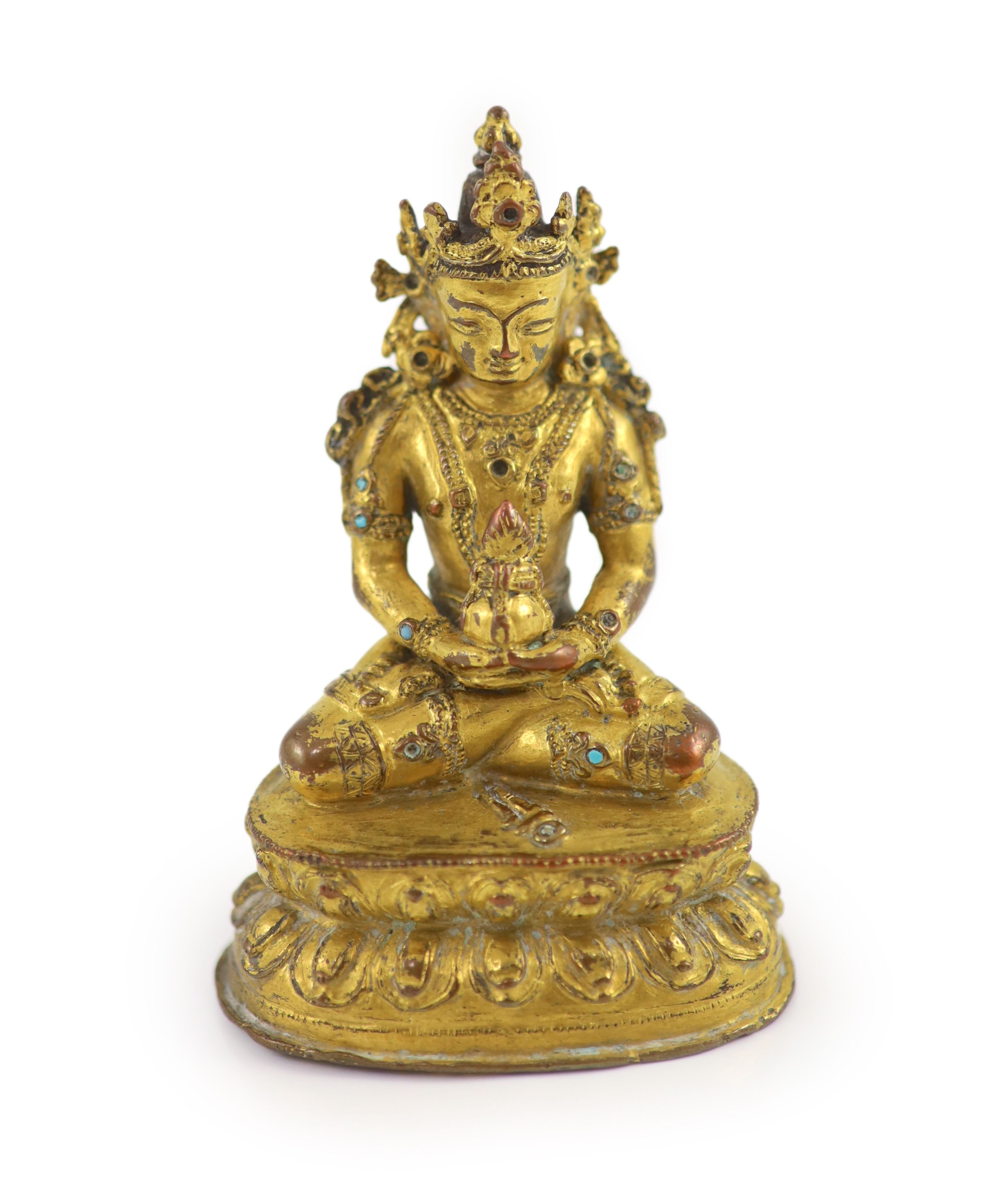 A Tibetan gilt copper alloy seated figure of Amitayus, possibly 15th/16th century, 9cm high